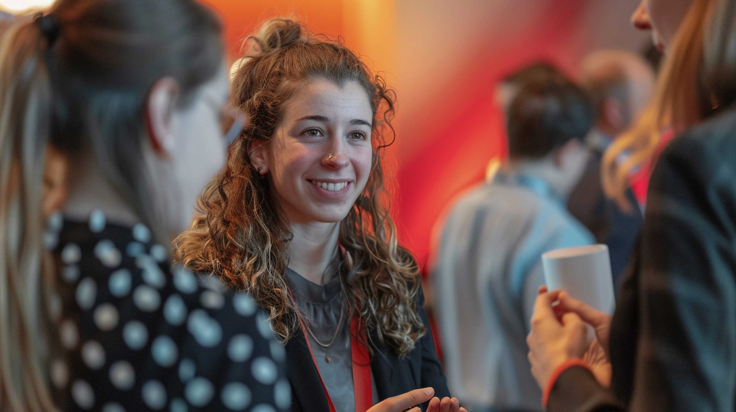 Woman entrepreneur networking at a business event - A confident woman at a business networking event, shaking hands and engaging in conversation with other professionals.